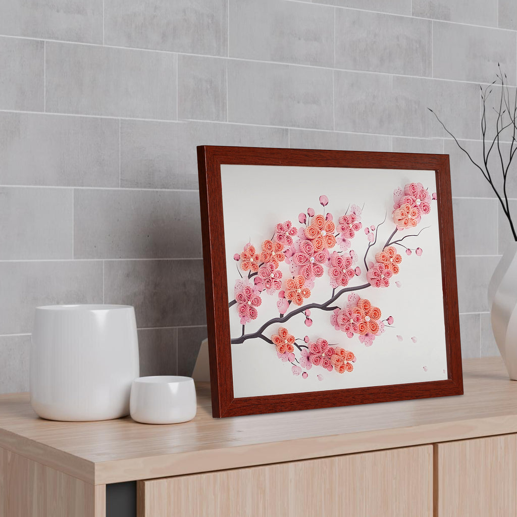 Framed artwork of cherry blossoms on a wooden surface with a gray tiled wall background