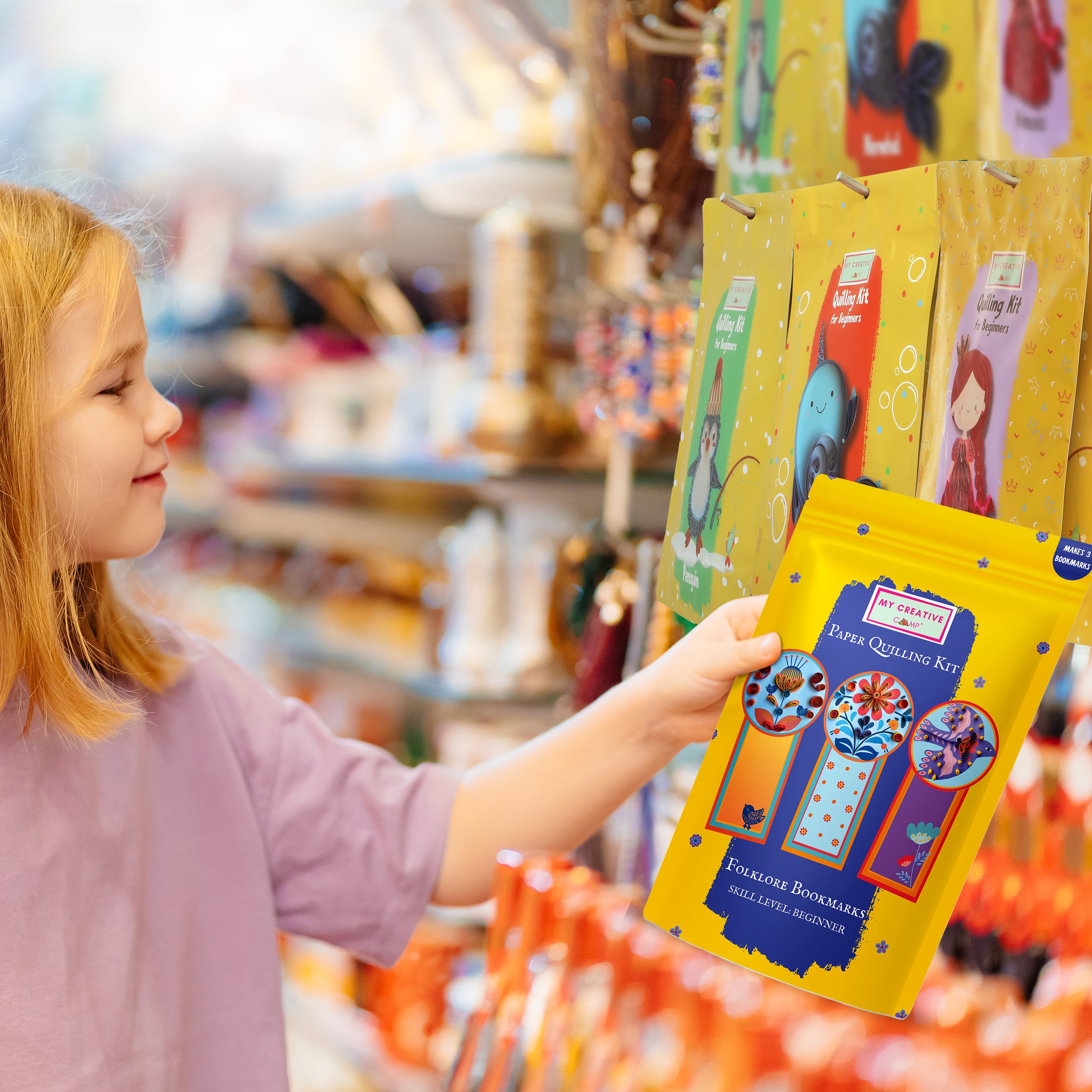 Child holding a yellow craft kit package in a store setting
Child choosing a paper crafting kit in a store aisle, highlighting gift suitability.