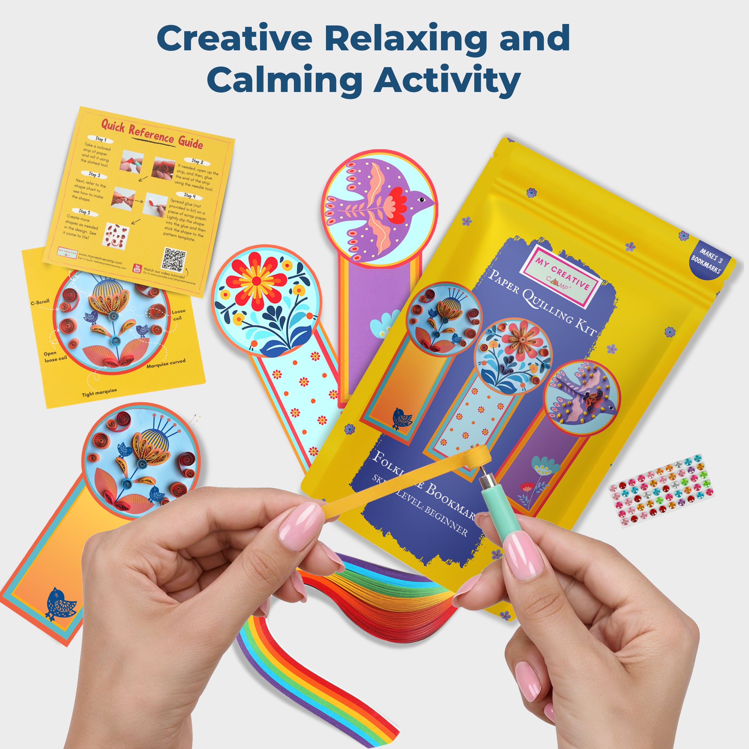 Hands holding a colorful paper quilling kit with instructions and samples on a white background.
Hands assembling paper quilling bookmark, demonstrating relaxing and calming craft activity.
