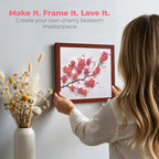 Person holding a framed cherry blossom artwork with text 'Make It. Frame It. Love It.' Child Flower Cherry