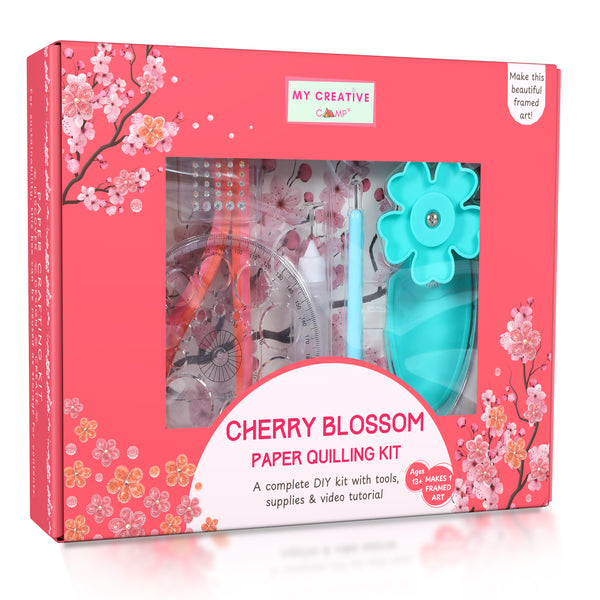 Cherry blossom paper quilling kit packaging with tools and supplies on a white background
Framed cherry blossom quilling artwork displayed on a minimal table with soft neutral background.
