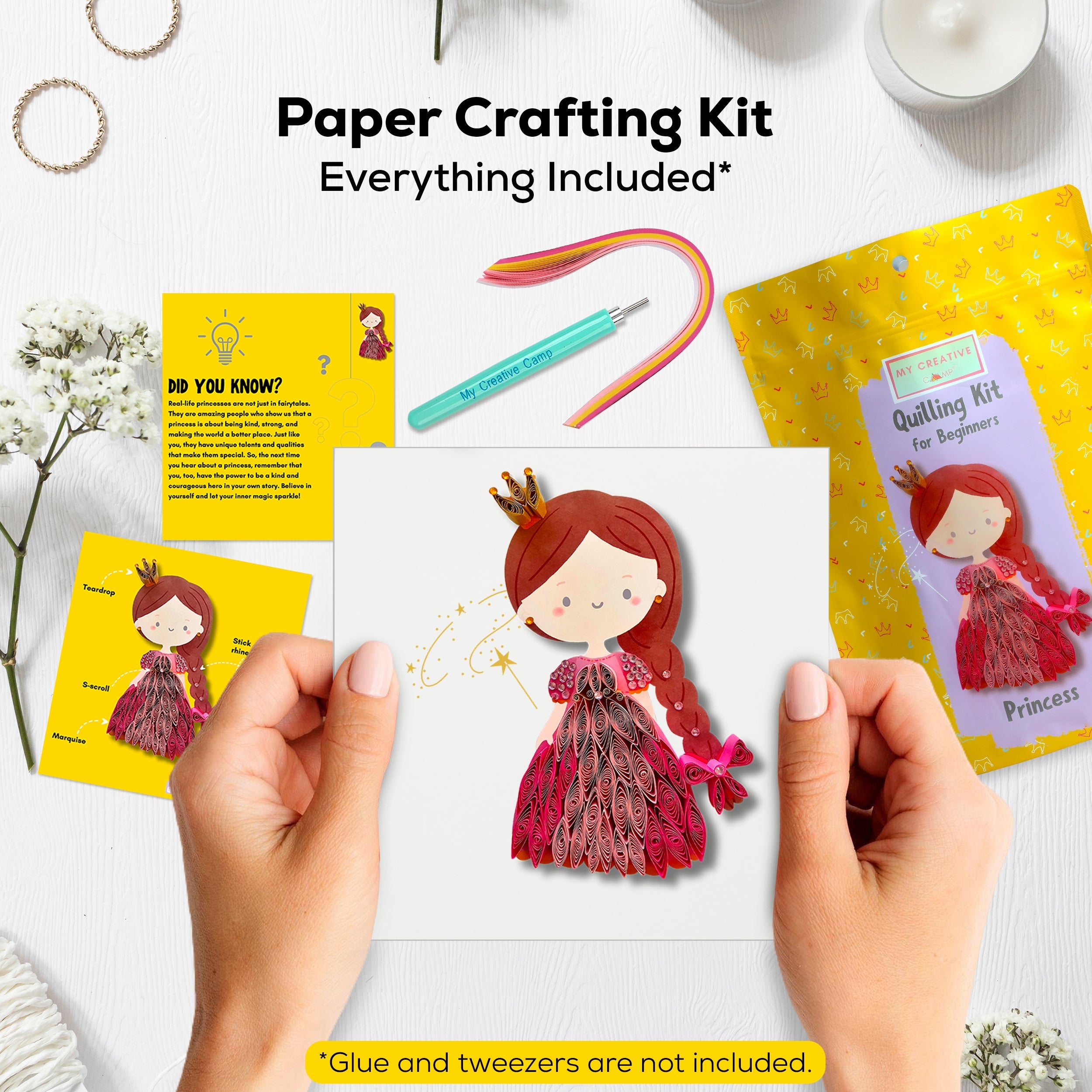 Paper crafting kit with princess-themed paper craft, glue, and tweezers on a white background.
Hands creating a princess paper quilling artwork using a beginner craft kit