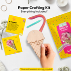 Paper crafting kit with ice cream cone template, cards, and a hand holding a wooden ice cream cone on a white background.
Hands creating an ice cream paper quilling artwork using an intermediate DIY craft kit