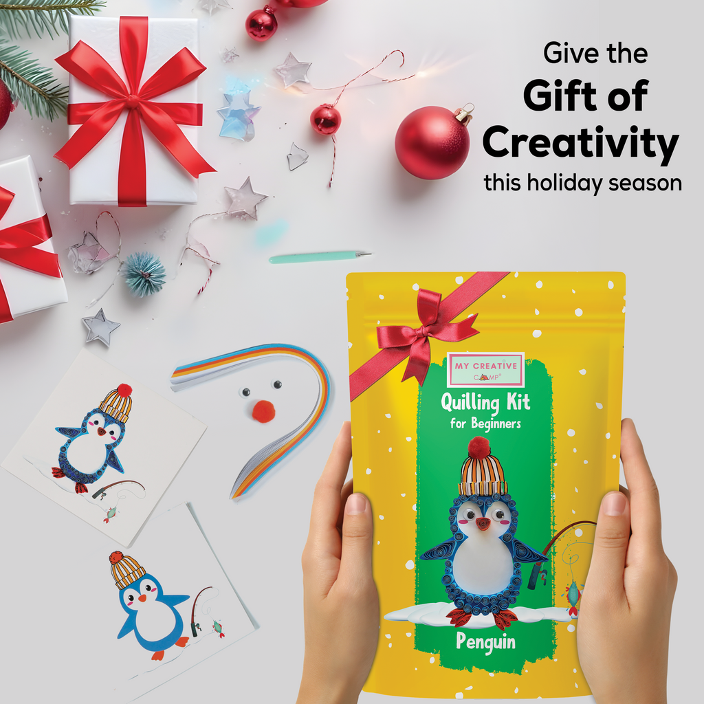 Quilling kit for beginners with penguin design, surrounded by Christmas decorations on a white background.