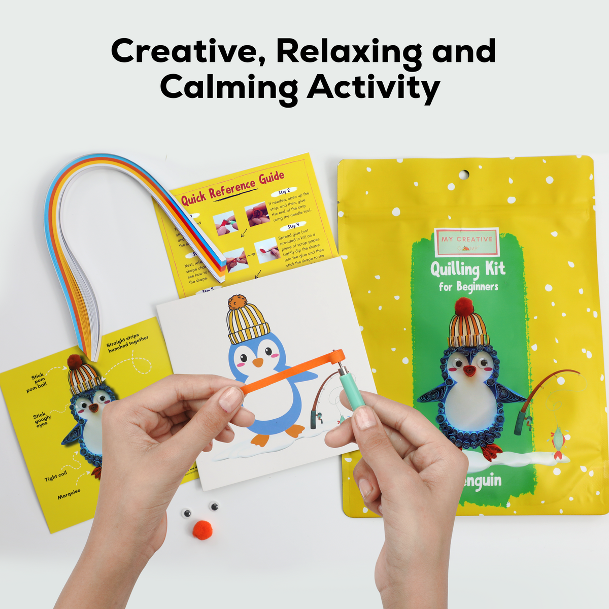 Paper quilling kit with penguin design, quilling tool, colorful paper strips, and accessories