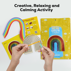 Quilling kit with rainbow design and hands using a tool on a white background