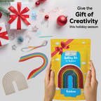 Quilling kit with rainbow design held by hands, surrounded by Christmas decorations on a white background.
Rainbow paper quilling kit shown as a creative gift idea for kids and beginners