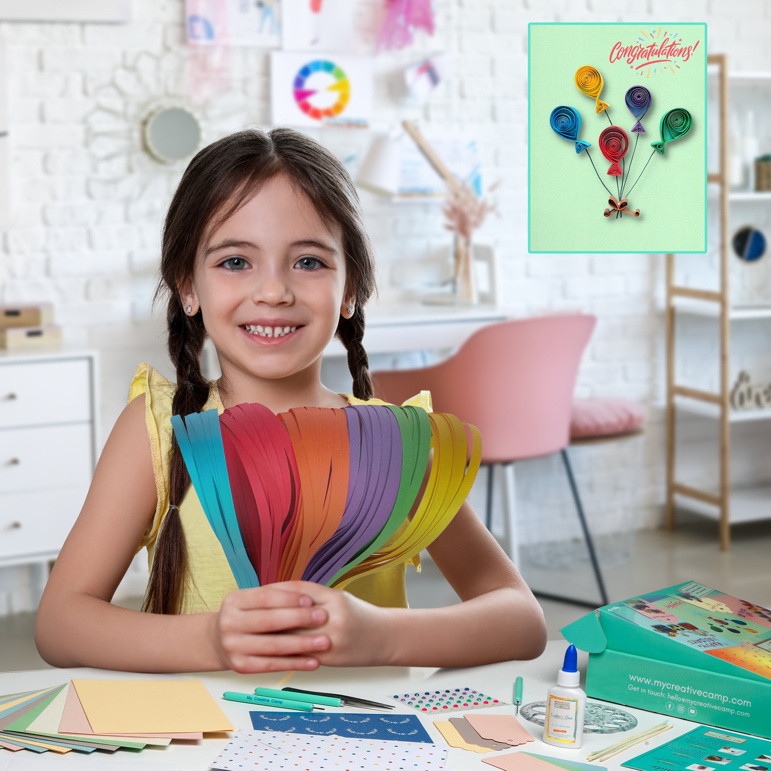 Child holding colorful paper strips with a craft kit and congratulations card in the background
Child holding colorful paper quilling strips from a beginner greeting card quilling kit