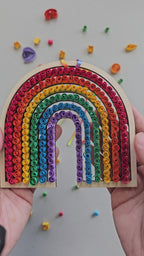 Handmade rainbow wall art created with a beginner paper quilling craft kit