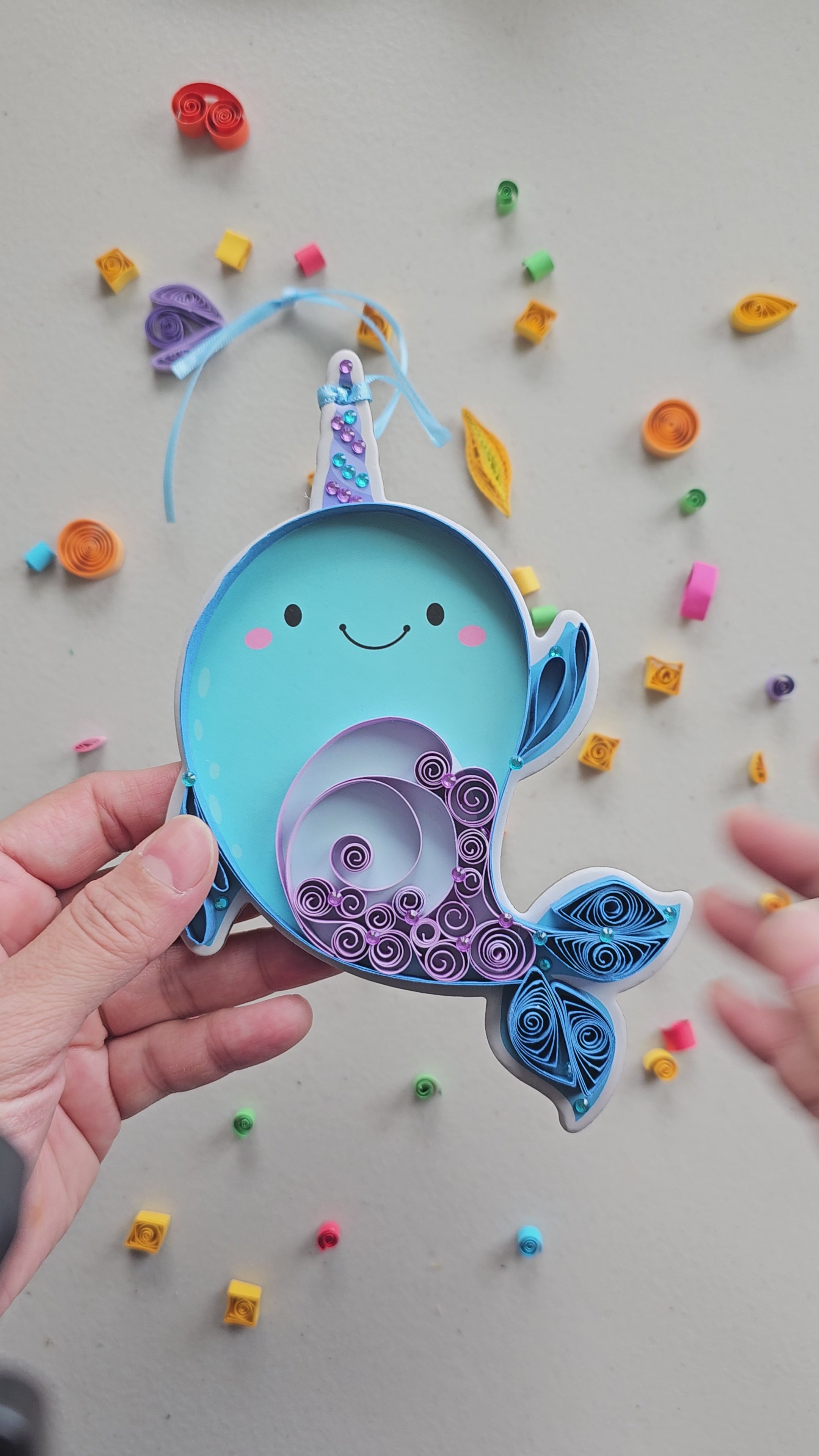 Finished narwhal paper quilling art made with an intermediate paper craft kit