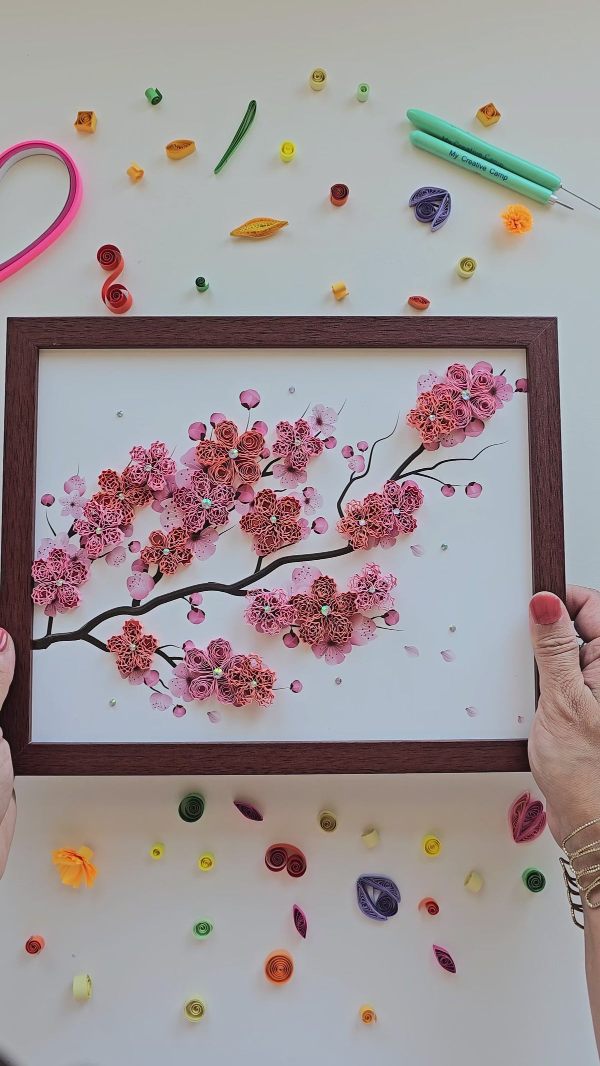 Top-down view of framed cherry blossom quilling art finished and framed
